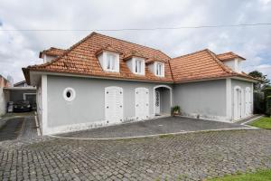 a white house with a red roof at 58 Studio in Ribeira Grande