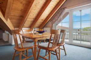 a dining room with a wooden table and chairs at Obst- und Ferienhof Lehle in Immenstaad am Bodensee