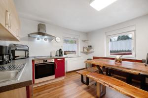 a kitchen with a wooden table and a wooden table sidx sidx sidx at Wasgauaktiv in Schindhard