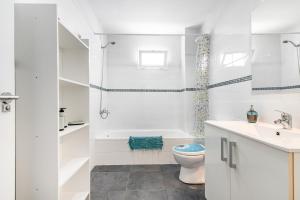 a bathroom with a tub and a toilet and a sink at Bright in Agaete +21 photos