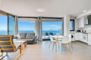 a kitchen and living room with a view of the ocean at Infinium 12b in Calpe