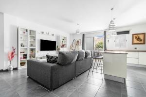 a living room with a couch and a kitchen at Bright in Agaete