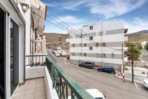 an apartment balcony with a view of a street at Bright in Agaete