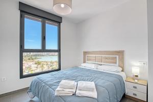a bedroom with a bed with two towels on it at Infinium 12b in Calpe +20 photos