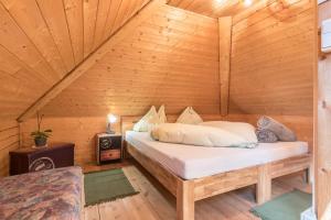 a bedroom with a bed in a wooden cabin at Apartment Vigl Lodge in Collalbo