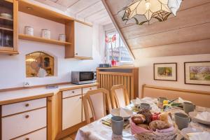 a kitchen with a table with food on it at Apartment Vigl Lodge in Collalbo +18 photos