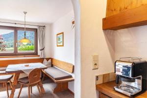 a small room with a table and a microwave at Anni in Leutasch
