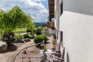 a patio with a table and chairs in a garden at Anni in Leutasch +20 photos