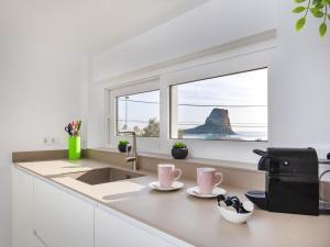 a kitchen with a sink and a window at Bennu in Calpe
