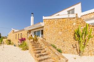 a stone house with a stone wall at Bennu in Calpe