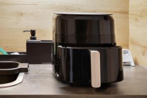 a coffee pot sitting on top of a counter at Global Bnb - Loft 28 Green in Augsburg +19 photos