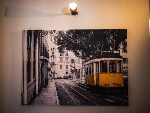 a black and white photo of a yellow streetcar at Casa na Vila T2 in Fuzeta