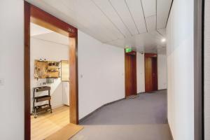 a hallway with an open door to a room at Global Bnb - Loft 28 Green in Augsburg