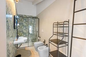 a bathroom with a toilet and a sink at Residenza Borgo Antico Lucia in Ascea +19 photos