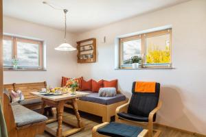 a living room with a couch and a table at Bauzinger Alm in Hauzenberg