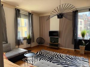 a living room with a zebra print rug at Appartement Neunkirchen City in Neunkirchen