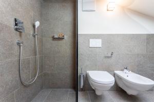 a bathroom with a shower with a toilet and a sink at Daimlhof Ferienwohnung Moosherz in Völs am Schlern +7 photos