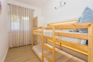 a bedroom with two bunk beds in a room at Refúgio Das Barcas in Lourinhã +37 photos