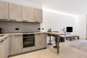 a kitchen with stainless steel appliances and a table at App 103 Palazzo Cavour in Bolzano +15 photos