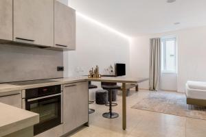 a kitchen with a table and a counter top at App 103 Palazzo Cavour in Bolzano