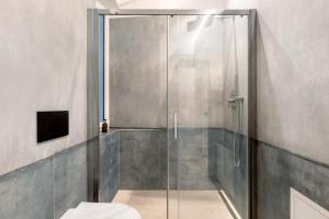 a shower with a glass door in a bathroom at App 103 Palazzo Cavour in Bolzano