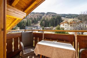 a table and chairs on a balcony with a view at Gartnerhof Apt Sonnenblume in Colle Isarco