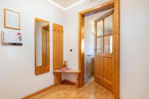 a room with a door and a mirror at Apartments Campagnola in Badia +125 photos