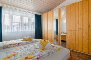 a bedroom with two beds and a mirror at Ferienwohnungen Böhme in Konstanz
