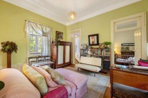 a living room with a couch and a table at Guest House Casa S Martinho in Oliveira de Azemeis
