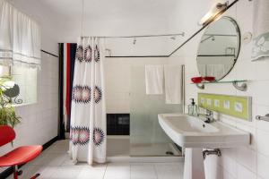 a bathroom with a shower curtain and a sink at Guest House Casa S Martinho in Oliveira de Azemeis +28 photos