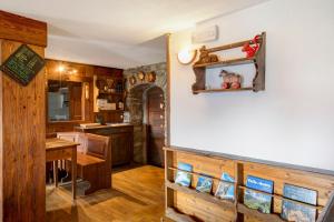 a kitchen with a counter and a table and a counter top at Agriturismo Les Ecureuils in Saint-Pierre