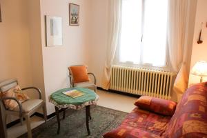 a living room with a couch and a chair and a window at Gîte Marion in Allemagne-en-Provence +21 photos