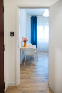 a dining room with a table and a blue curtain at Oltremare in Molfetta +28 photos