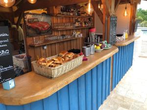 a counter with a basket of loaves of bread at Cabane Spa - Noyers - Proche Sarlat in Jayac