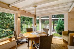 a screened in porch with a wooden table and chairs at Ferienhaus Piet in Berumbur