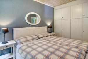 a bedroom with a bed and a mirror on the wall at Ferienhaus Piet in Berumbur