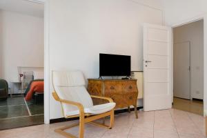 a living room with a chair and a television at Il Mughetto in Rapallo