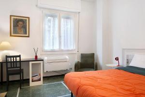 a bedroom with a bed and a desk and a chair at Il Mughetto in Rapallo