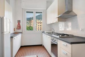 a kitchen with white cabinets and a window at Il Mughetto in Rapallo