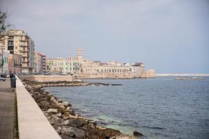 a view of the water with buildings and a beach at Oltremare in Molfetta