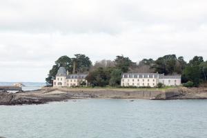 a large house on the shore of a body of water at Appartement face Mer - 50m plage in Douarnenez