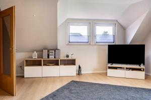 a living room with a flat screen tv in a attic at Ferienwohnung Heimathafen in Cuxhaven