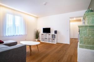 a living room with a couch and a table at Ferienwohnung Lauterach in Lauterach