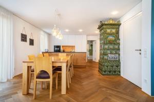 a kitchen and dining room with a wooden table and chairs at Ferienwohnung Lauterach in Lauterach