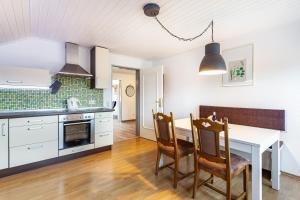 a kitchen with a table and chairs in a room at Lydias Ferienwohnung in Schmallenberg