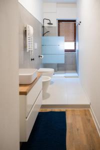 a bathroom with a white sink and a toilet at Oltremare in Molfetta