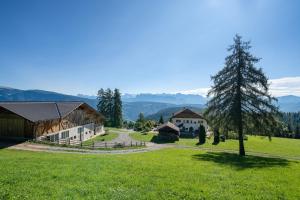 a view of a farm with mountains in the background at Wohnung Arnika Stücklhof in San Genesio Atesino
