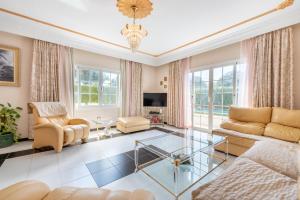 a living room with a couch and a glass table at Villa Son Ferrer in Santa Ponsa