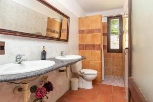 a bathroom with two sinks and a toilet at Masía Can Garriga, Casa Gran in Girona +22 photos