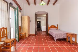 a bedroom with a bed and a table and chairs at Masía Can Garriga, Casa Gran in Girona